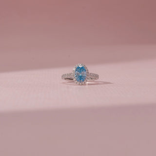 Front view of Oval Blue Diamond Halo Ring in 14KT White Gold, featuring a blue oval diamond with a sparkling halo.