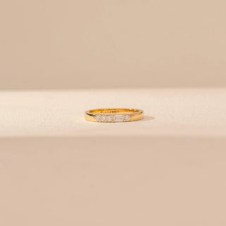 Front view of Minimal Diamond Band Ring in 14KT Yellow Gold, featuring a slim band with round and baguette diamonds.