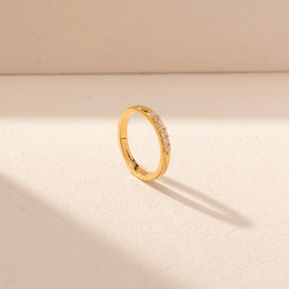 Angled  view of Minimal Diamond Band Ring in 14KT Yellow Gold, featuring a slim band with round and baguette diamonds.