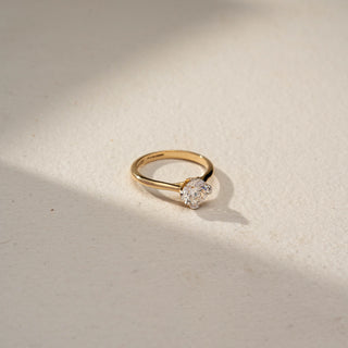 Top view of a minimalist yellow gold solitaire ring featuring a round brilliant-cut diamond in a sleek prong setting, showcasing timeless elegance and refined simplicity.