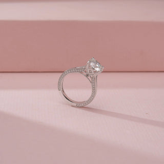 Angled view of a 14KT White Gold diamond ring, featuring a round centre diamond and a sleek sculpted band.