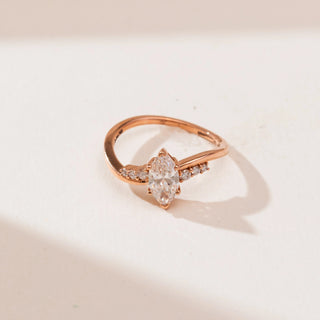 Top view of Modern Yellow Gold Diamond Ring in 14KT yellow gold, featuring a vertically set marquise centre diamond with round accent diamonds along a softly curved polished band.