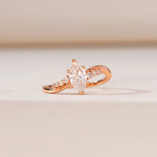 Front view of Modern Yellow Gold Diamond Ring in 14KT yellow gold, showcasing a vertically set marquise centre diamond with round accent diamonds on a gently curved polished band.