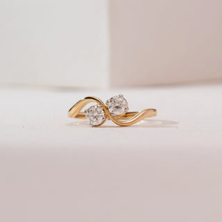 Front view of Radiant Golden Duo Diamond Ring in 14KT yellow gold, showcasing two round brilliant diamonds on a flowing S-shaped bypass band.