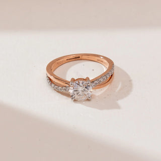 Top view of Intertwined Rose Gold Diamond Ring in 14KT rose gold, featuring a round centre diamond held by four prongs with a split shank of polished and pavé-set diamond bands.