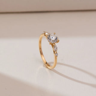 Side profile view of Classic Tapered Accent Diamond Ring in 14KT yellow gold, showcasing a round centre diamond with marquise and round tapered side accents on a slim band.