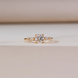 Front view of Classic Tapered Accent Diamond Ring in 14KT yellow gold, featuring a round centre diamond with marquise-shaped tapered side accents on a slender polished band.