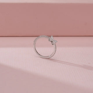 Angled view of a 14KT White Gold diamond ring, featuring marquise diamonds arranged in a floral design.