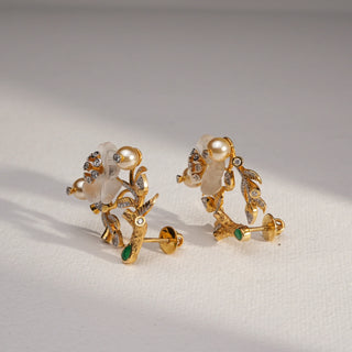 Side view of Golden Blossom Pearl Diamond Earrings in 14KT Yellow Gold, featuring a floral design with EF VVS diamonds, pearls, and green enamel accents for a radiant natural elegance.