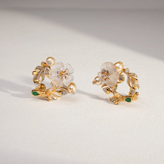 Golden Blossom Pearl Diamond Earrings in 14KT Yellow Gold, featuring floral motifs with EF VVS diamonds, pearls, and green enamel accents, reflecting nature’s beauty and timeless elegance.
