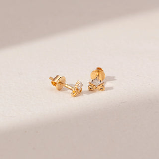 Angled view of Bow Diamond Earrings in 14KT Yellow Gold, featuring round lab-grown diamonds with delicate bow designs.