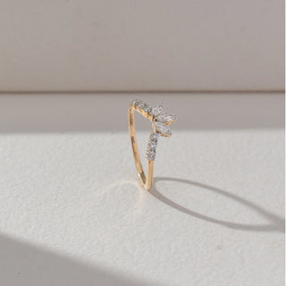 Side view of Marquise Cluster Diamond Ring in 14KT Yellow Gold, featuring marquise and round lab grown diamonds in a crown-like arrangement with pavé band. Set on a beige backdrop, the design highlights structure and elegance.
