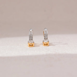 Front view of diamond bar stud earrings in yellow gold, featuring vertical rows of round lab-grown diamonds with a single round diamond at the base. Set on a soft neutral backdrop, they reflect minimal elegance.