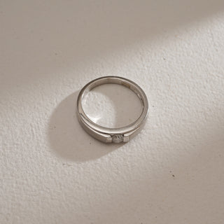 Top view of Men’s Sleek Diamond Engagement Ring on beige background. Made in 14KT hallmarked white gold, size 20, featuring EF colour, VVS clarity lab grown diamond weighing 0.257 carats in total. The product weighs 4.37 grams, priced INR 15,000–50,000.