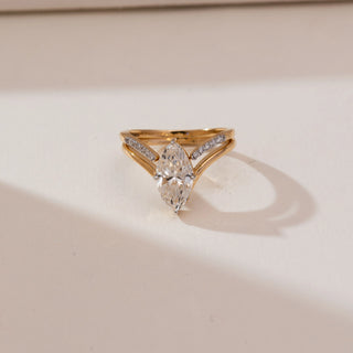 Front view of Marquise Bypass Split Diamond Ring in yellow gold, featuring a marquise-cut lab-grown diamond held by a split bypass band with pavé diamond accents, displayed on a soft beige backdrop.