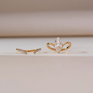 Front display of Marquise Bypass Split Diamond Ring in yellow gold, featuring a marquise-cut lab-grown diamond paired with an open split bypass band accented by pavé diamonds, set on a soft beige surface.