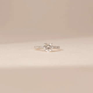Front view of a 14KT White Gold diamond ring, featuring a round centre diamond and diamond-set shoulders.