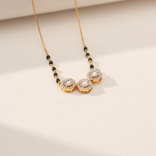 Angled view of Triple Bloom Round Diamond Mangalsutra in 14KT Yellow Gold, featuring three floral motifs with round lab-grown diamonds.