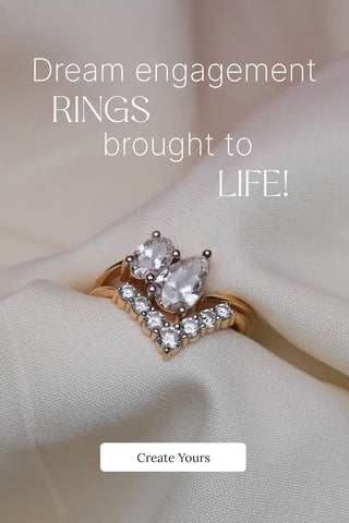 Pear-cut and round-cut diamond engagement ring set in a gold band, displayed on smooth ivory fabric with “Dream engagement rings brought to life” text, capturing romance and elegance.