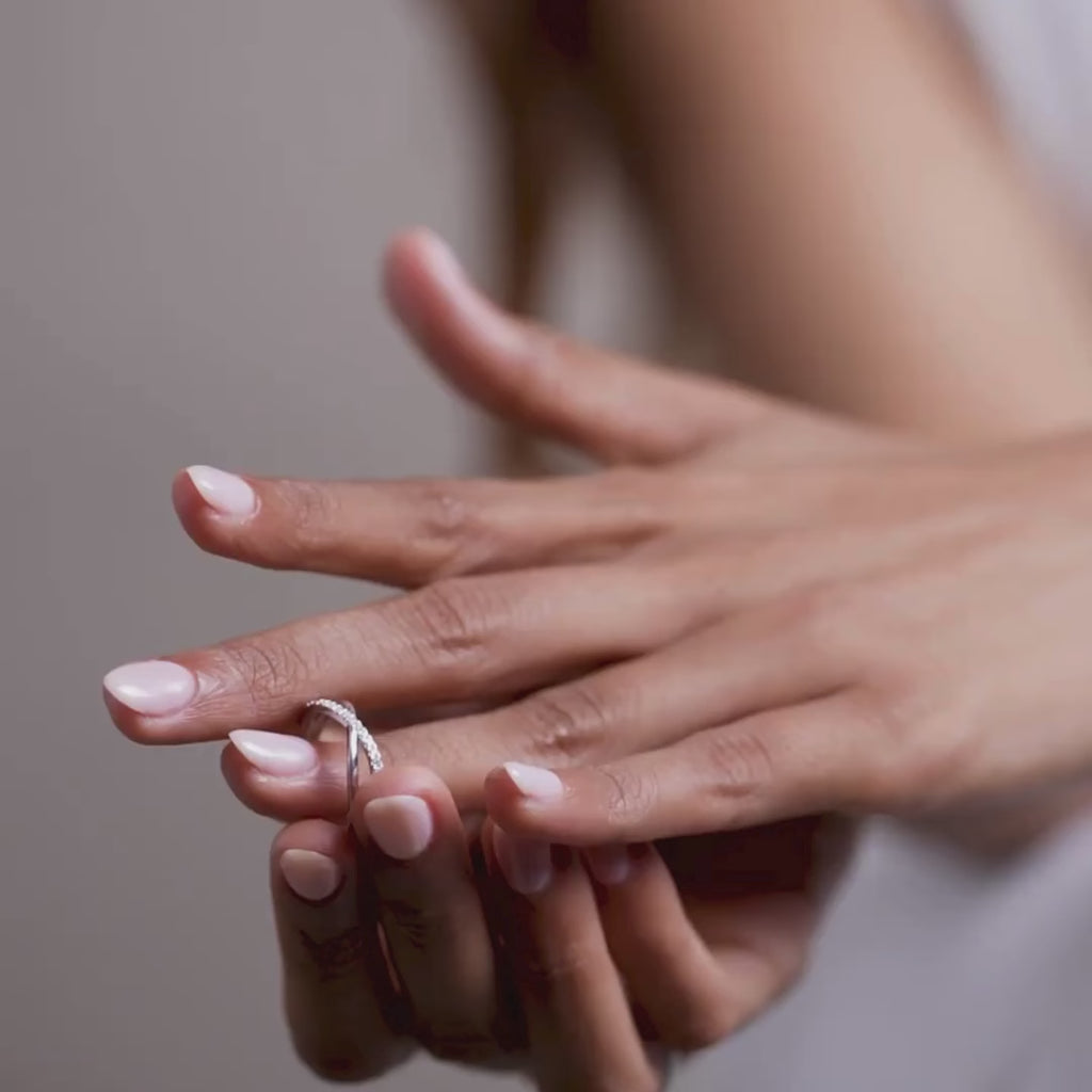 A slim lab-grown diamond ring styled on the finger, featuring a gently contoured band and subtle sparkle, captured in a relaxed lifestyle pose against a soft neutral background with natural light.