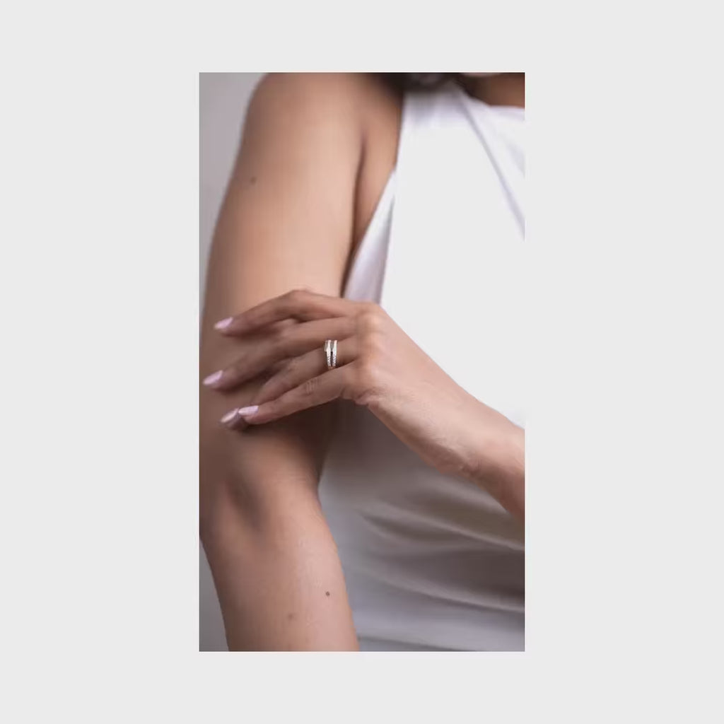 Slim lab-grown diamond eternity band with pavé-set stones worn on the finger, styled against a soft neutral background.